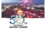 Aerial of fireworks over the City at night with the Meridian Water Tower 50th Anniversary logo place where the Water Tower is in the image.