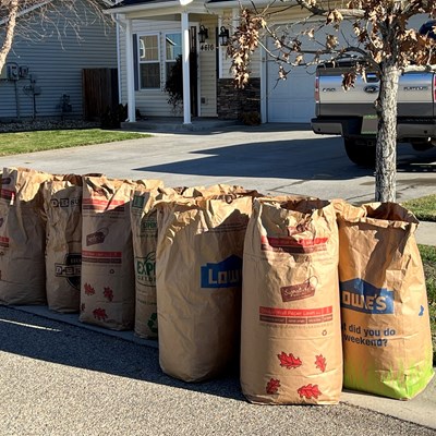 Brown paper leaf bags set out on the curb in Meridian for curbside leave pick up